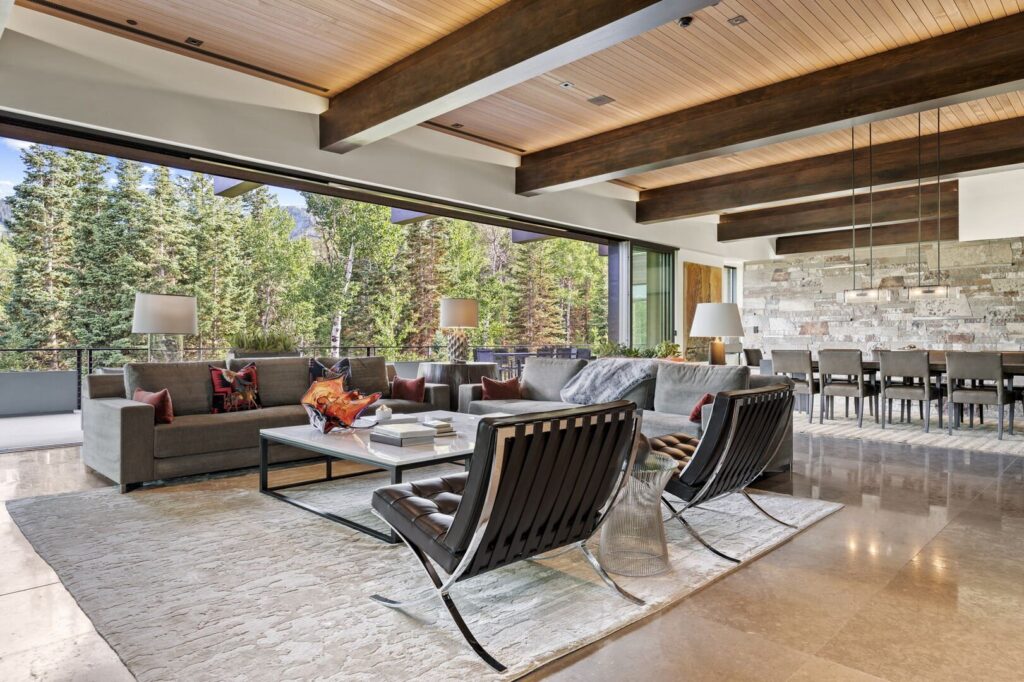 A luxury vacation rental in park city utah. there is a view of the forest from a modern living room.