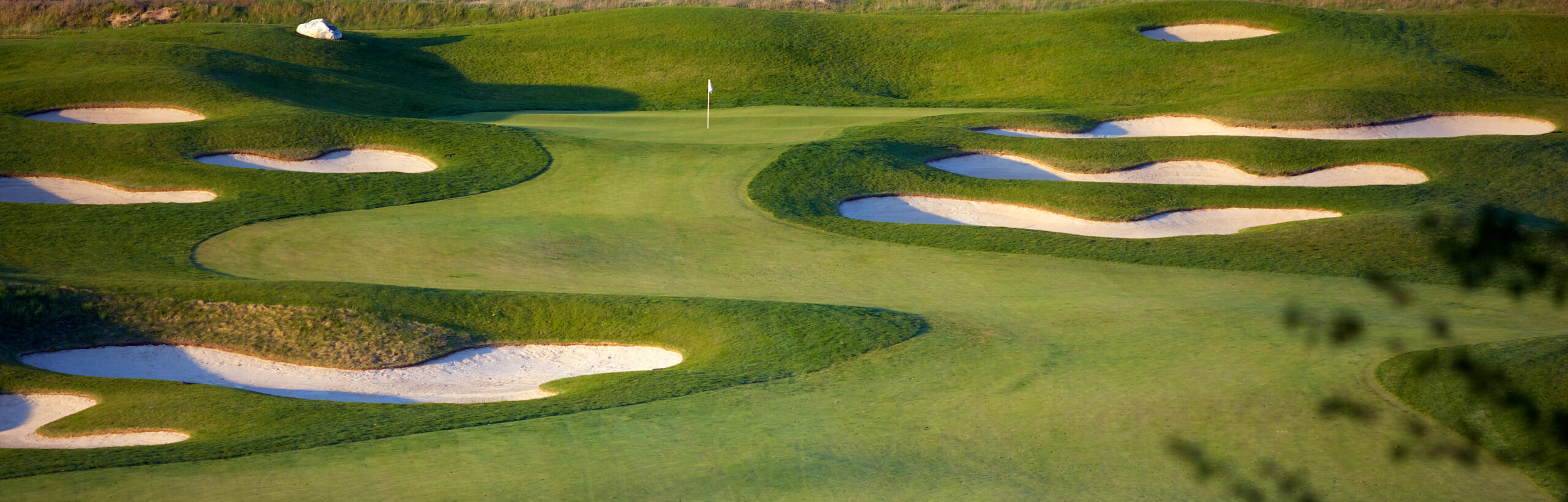 Early morning spring scene of a beautiful golf course in park city hole with vibrant colors.