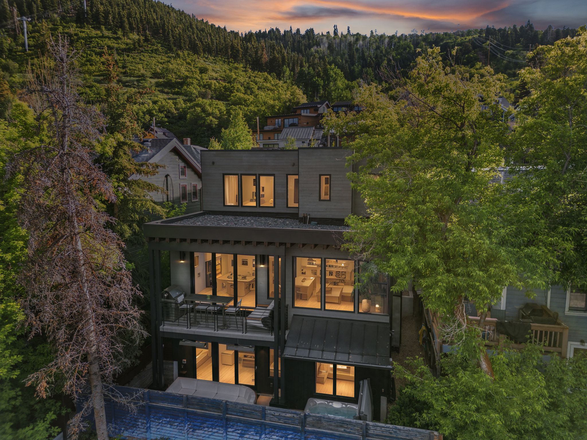 Luxury vacation rental surrounded by trees with terraced patios in the heart of park city