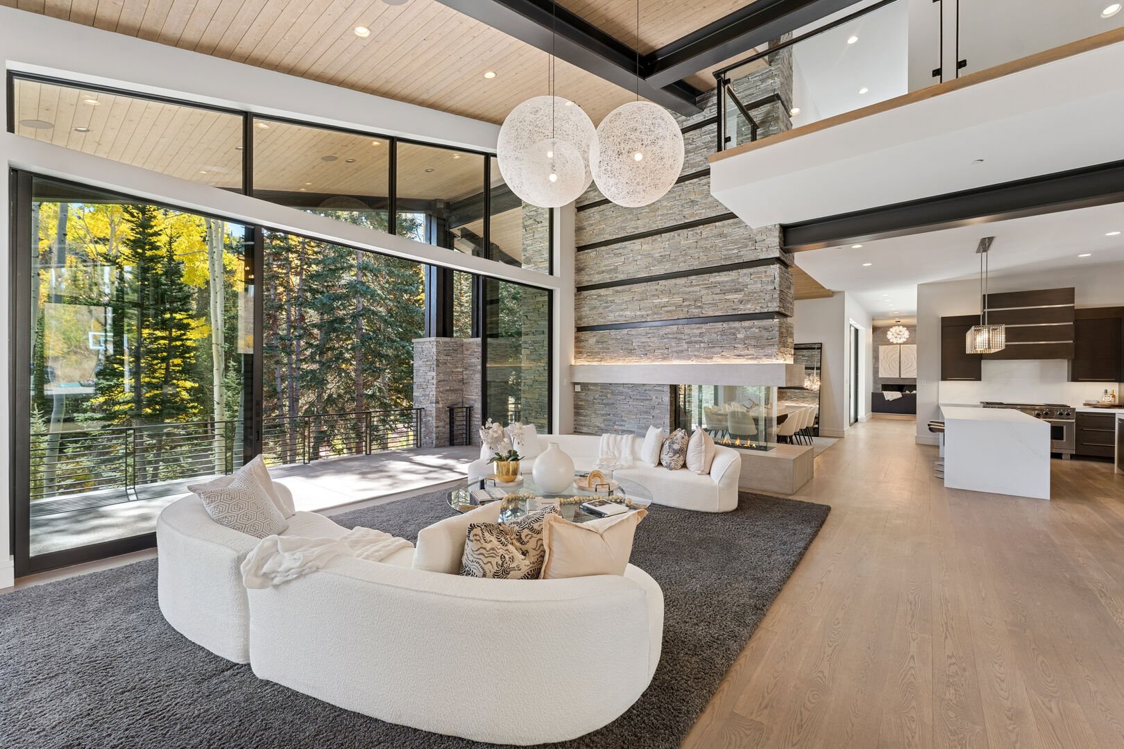 The designer living area at All In with white plush couch and modern lighting The designer living area at All In with white plush couch and modern lighting