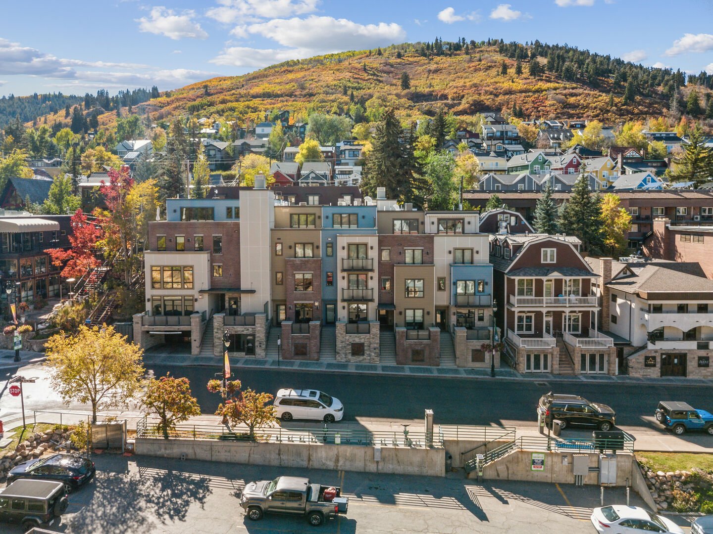 an image of a condo building in old town park city on main street with ski runs in the background