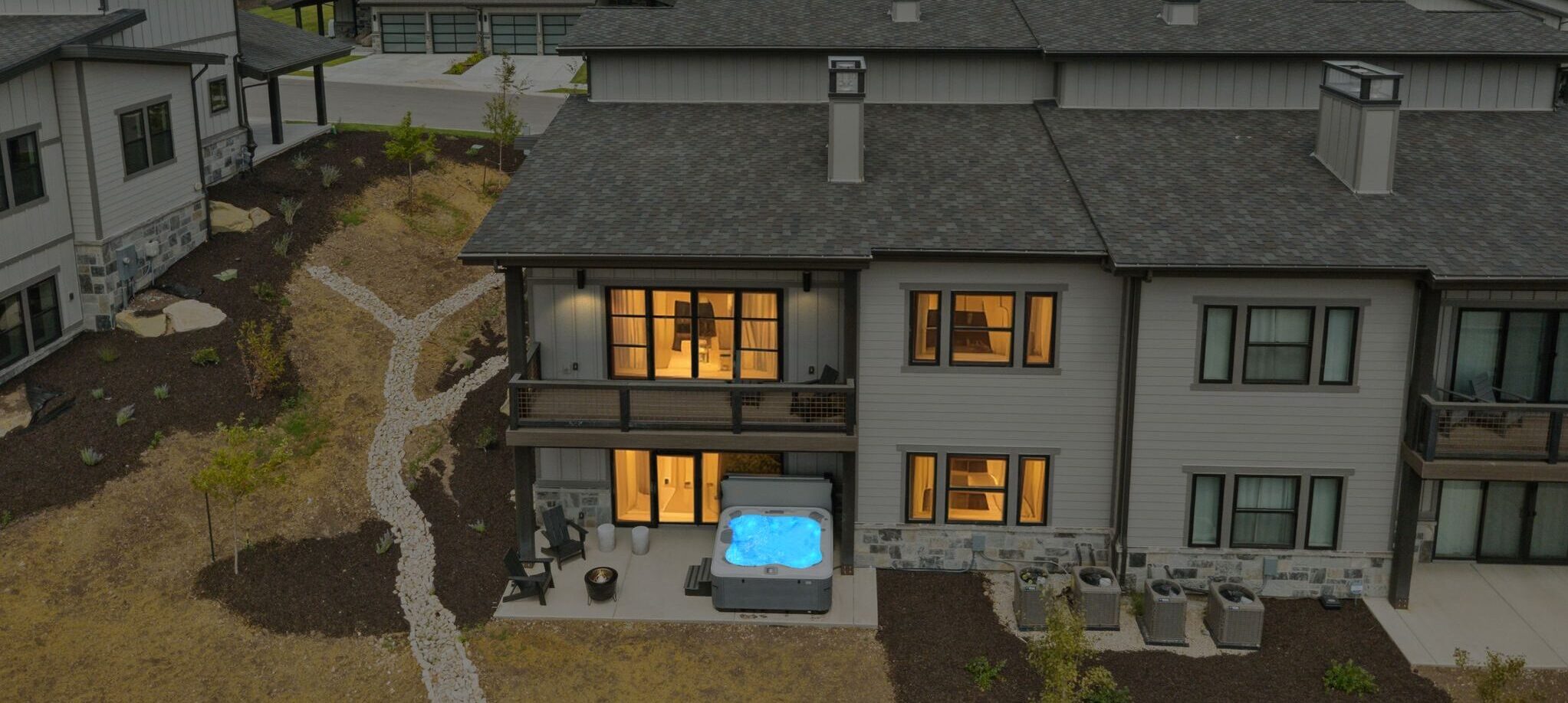 Deer Valley Vista at dusk with glowing windows and a warm hot tub waiting for guests