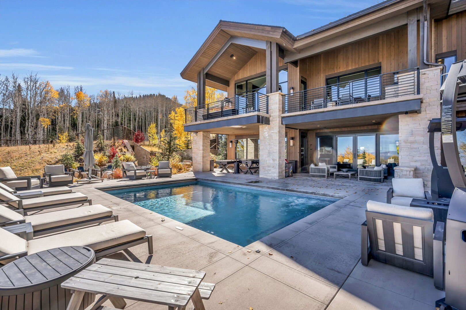 the pool area at sanctuary with the fall colors of aspens in the background and the mountains of park city visible