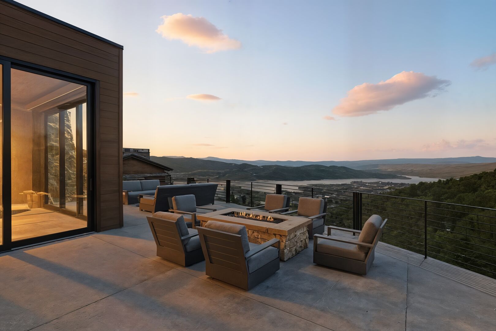 The outdoor lounge space at star gazer overlooking deer valley at sunset with a firepit and ample outdoor seating