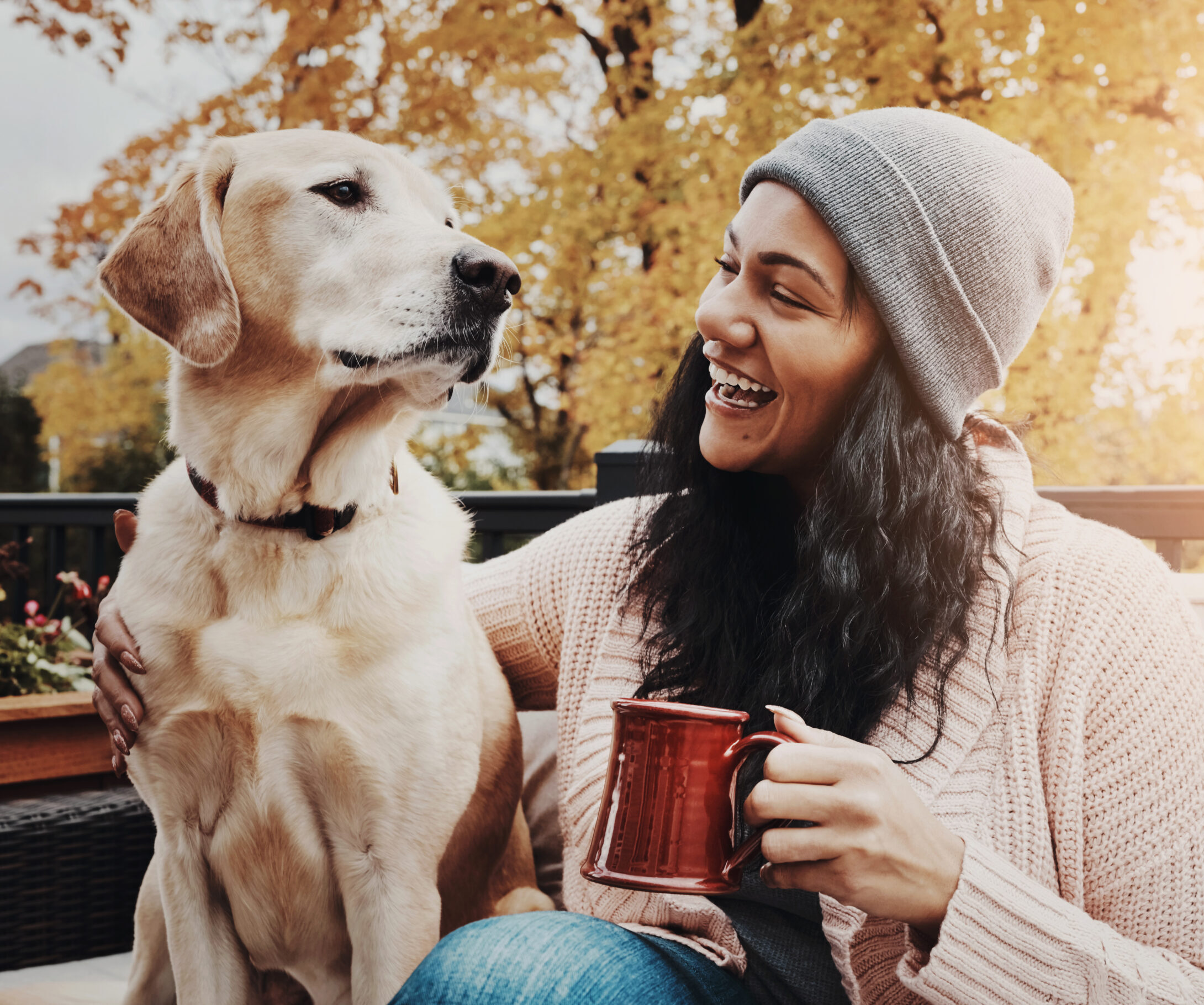 Smile, woman and dog on bench with coffee, happy and love in autumn.
