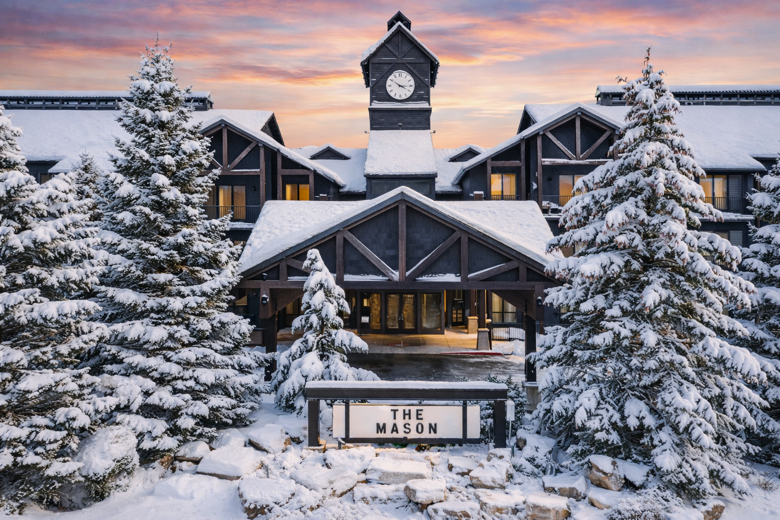 the entrance to The Mason at Deer Valley East, covered in snow during sunset