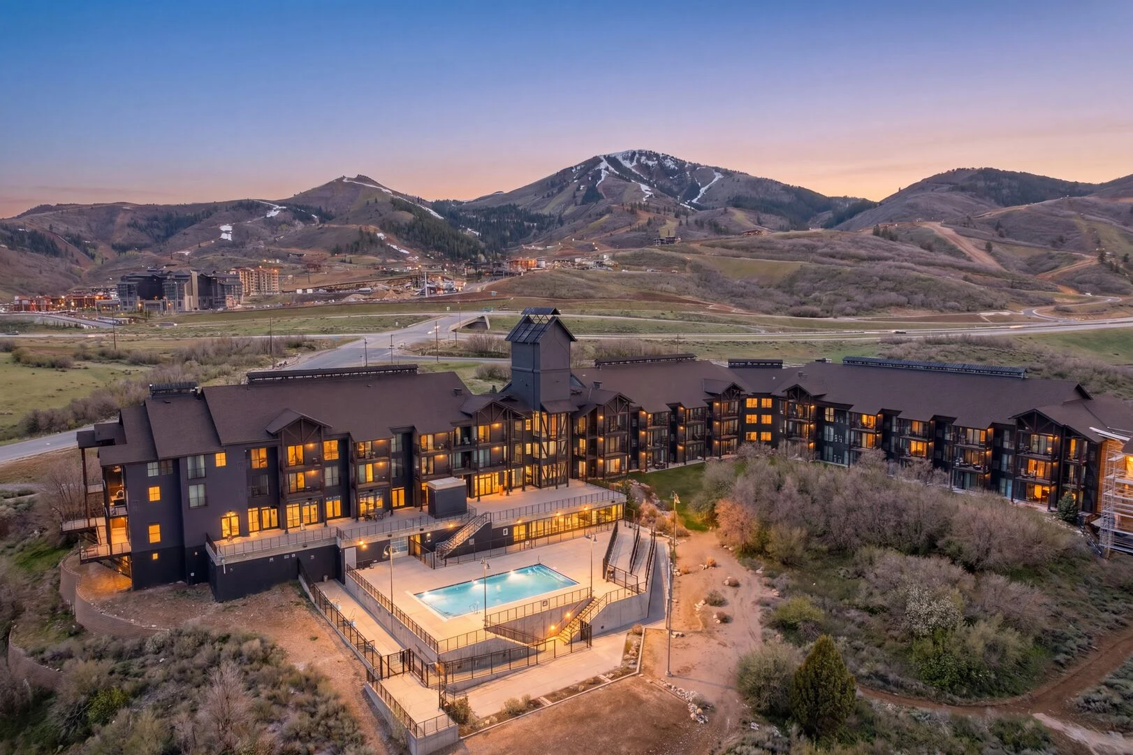 The Mason Resort at dusk with views of the mountains of Deer Valley in the background
