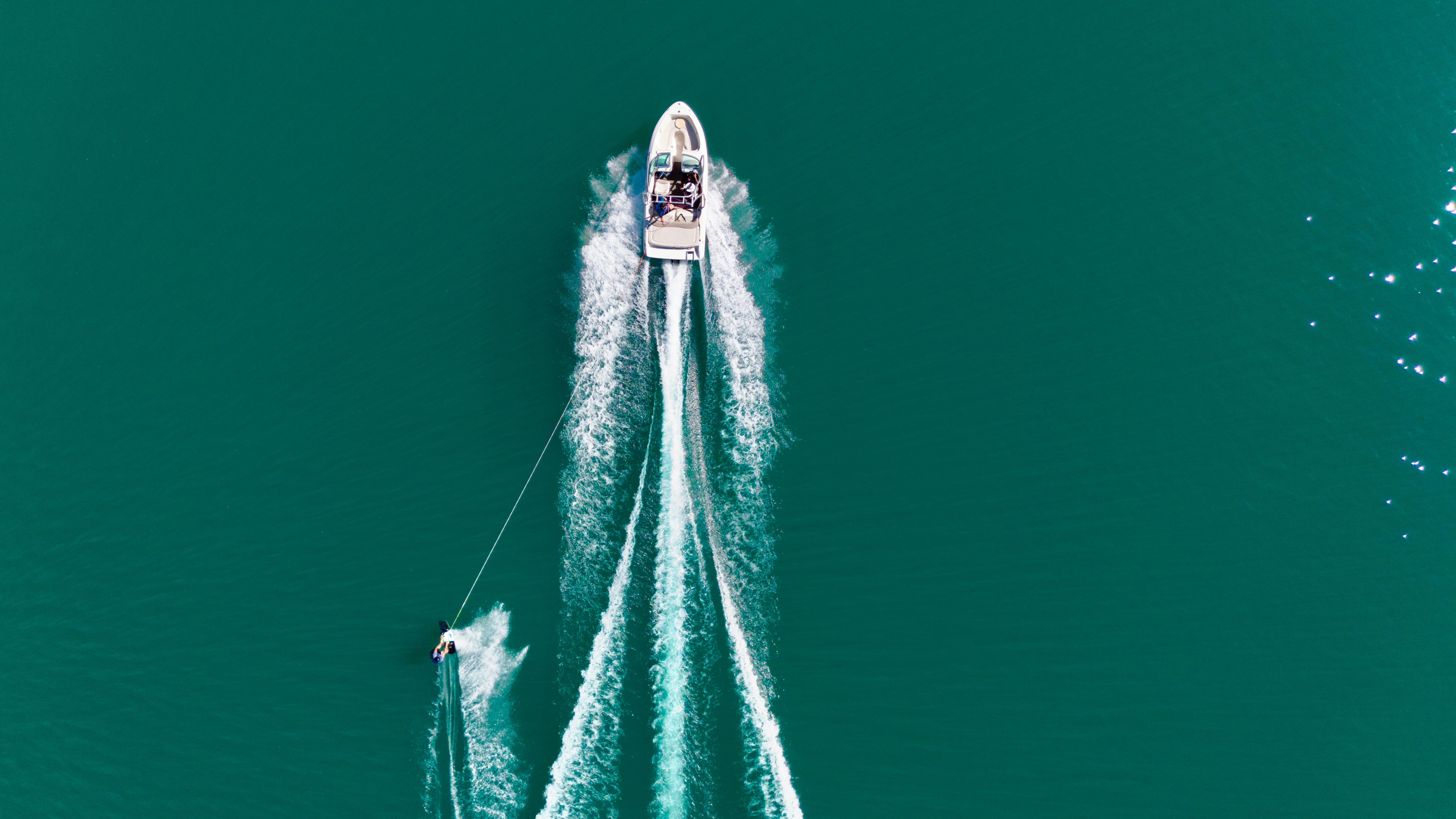 a mastercraft boat tows a skier on Deer Creek in Park City