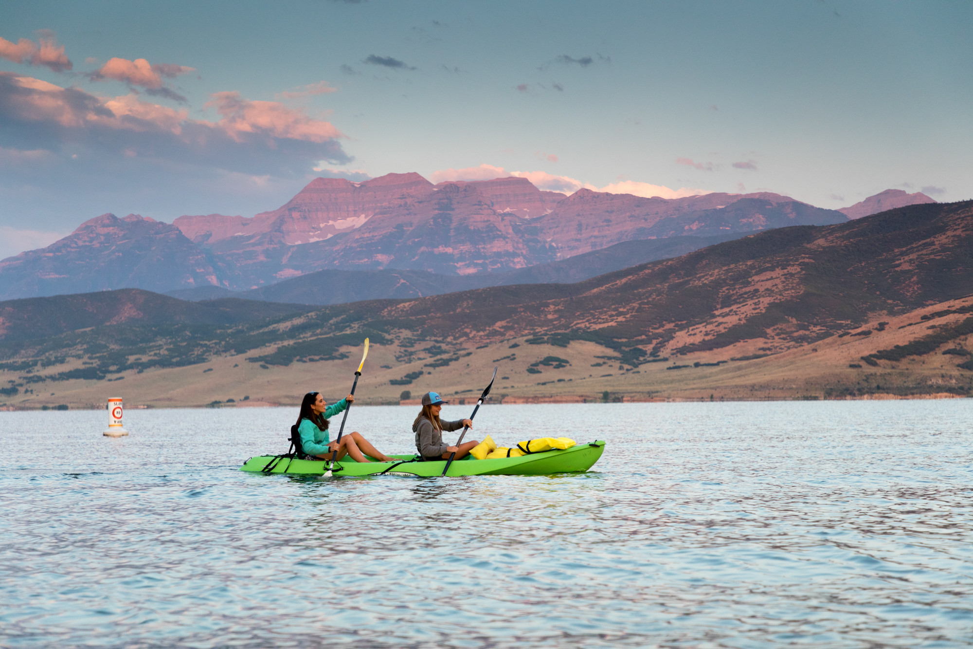 kayaking at sundown in deer creek with the mountains in the distance