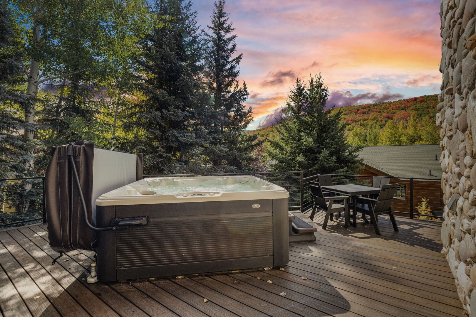 the hot tub with mountains and sunset sky in the distance at Deer valley bliss, a luxury rental in park city